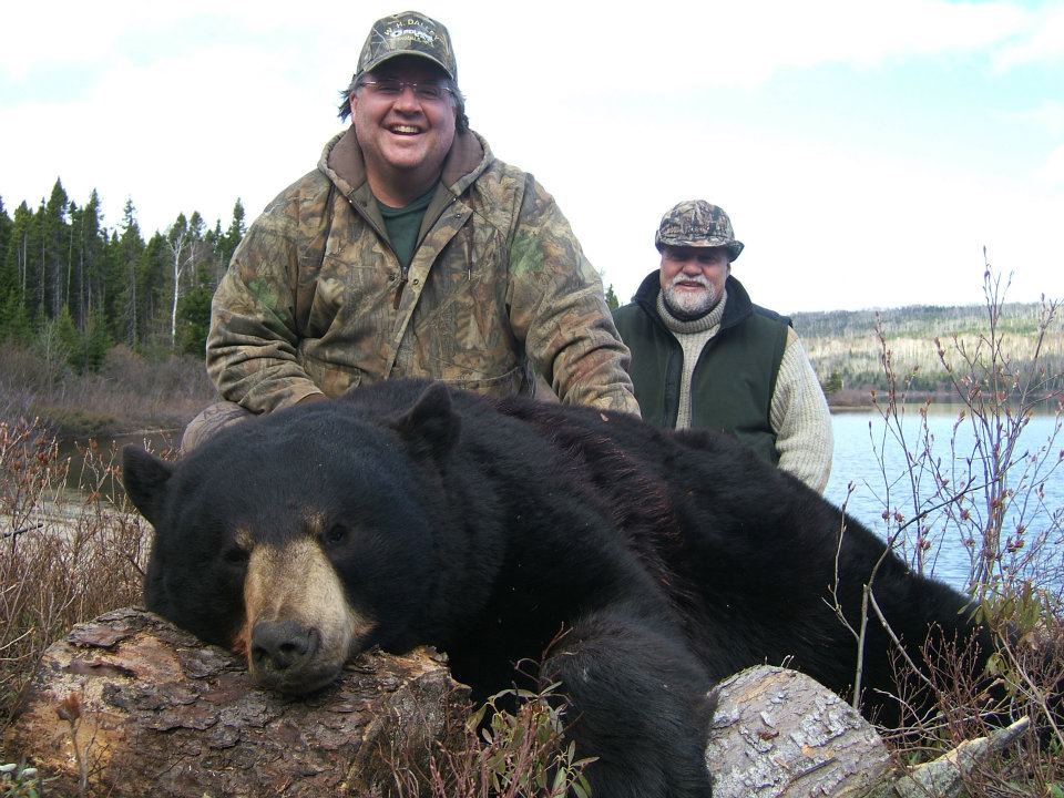 hunters posing with big game bear